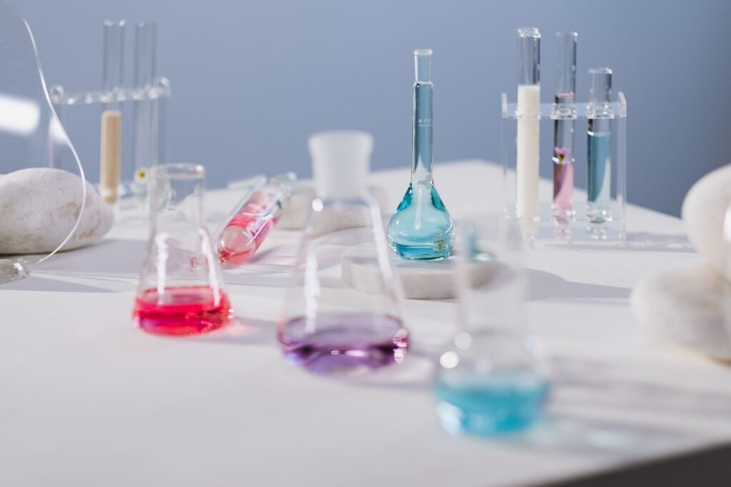 Vibrant liquids in glassware on a laboratory table in a modern science setting.
